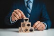© AshProject - Wooden blocks with business-related symbols forming a pyramid.