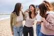© PintoArt - Four young women walking and having fun on the beach