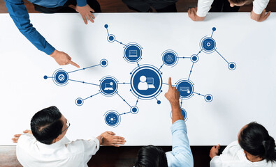 Fototapete - A group of business professionals is collaborating around a table, analyzing a digital network diagram symbolizing data flow and innovative technology concepts. Amity