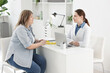 © New Africa - Weight loss. Nutritionist consulting overweight woman at white desk in clinic