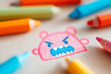 Naive crayon art depicting an exaggerated angry face