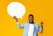 © Prostock-studio - I have an idea. Inspired african american man holding empty speech bubble on yellow studio background, copy space