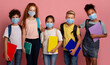 © Prostock-studio - Virus epidemic and schooling. Multiethnic kids in medical masks holding notebooks on pink background