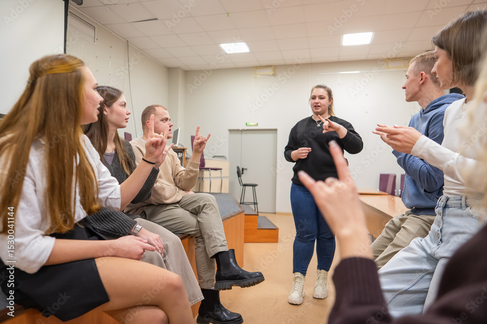 Young people communicate in sign language in a university classroom ...