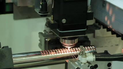 Aufkleber - Automatic machine cuts holes in metal tube with laser and flame and sparks, industrial metal concept