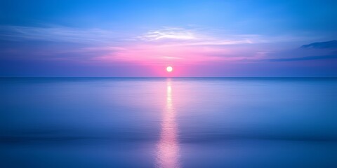 Poster - Beautiful blue ocean with a pink sun in the sky. The sun is setting and the water is calm