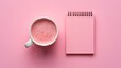 © SM_Studio - Frothy pink drink beside a matching spiral notebook on pink backdrop