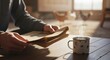 © ferifadli - Close-Up of a Man Reading an Old Newspaper While Drinking Coffee on the Terrace of a Stilt House