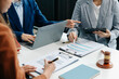 © laddawan - business people and lawyers discussing contract papers sitting at the table. Concepts of law, advice, legal services.