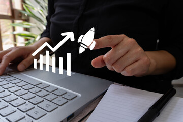 Poster - A person uses a laptop with a business growth graph and a rocket icon. This represents the concept of business success.