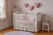 © Eibrahim Imagery - A crib with pink bedding and heart decorations in a nursery with wooden floorings
