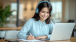 © Ada - Smiling girl wear wireless headphone study online with skype teacher, young woman with dark hair, wearing blue over-ear headphones and a light blue long-sleeved shirt