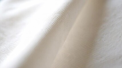Poster - Texture of Elegance: The close-up unveils delicate ivory fabric, each fiber interwoven to create a captivating visual of texture and subtle movement, embodying sophistication and softness.