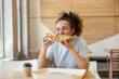 © Dusan Petkovic - Hungry young woman biting and eating pizza in fast food restaurant.