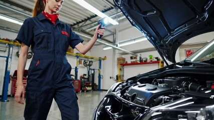 Aufkleber - Confident mechanic blue uniform inspects car engine with flashlight during auto repair shop inspection, focused engine repair
