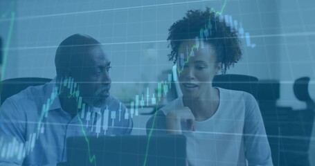 Poster - Two colleagues pointing laptop screen launching candlestick charts showing market recovery