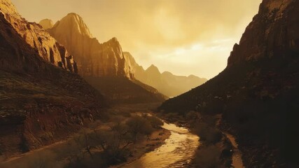 Poster - A golden sunset illuminates a winding river flowing between towering canyon cliffs and rugged mountain peaks.