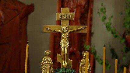 Aufkleber - A golden crucifix surrounded by candles, set against a background of a statue