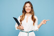 © ViDi Studio - Young successful employee business woman corporate lawyer wears shirt formal clothes work in office hold clipboard with paper account documents point aside isolated on pastel blue background studio.
