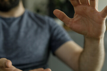 Poster - Close-up of a man's hands reaching out, wearing a simple t-shirt.  Perfect for concepts of connection, help, or openness.