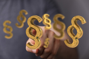 Aufkleber - Abstract image of golden paragraph symbols hovering near a hand, symbolizing law, legal, justice.
