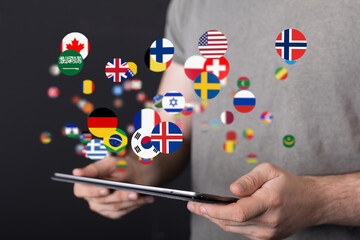 Aufkleber - Image of a person holding a tablet with digital world flags.  Global communication concept.