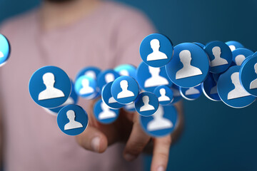 Leinwandbilder - Hand interacting with floating profile icons, symbolizing networking, social media, and online community. Ideal for business, technology, and social media