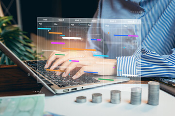Poster - Planning business. Business Professional Using Laptop to Create Gantt Chart for Project Management with Coins and Plant in Background