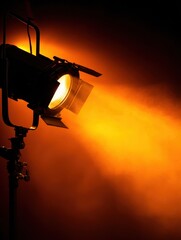 Poster - A spotlight illuminating a dramatic scene with warm orange hues and smoke effects