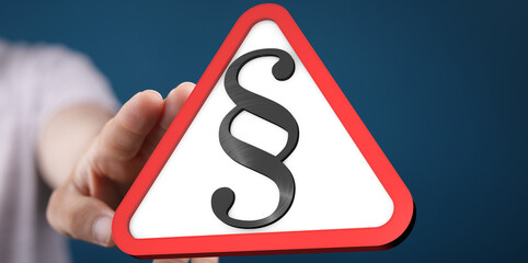 Aufkleber - Hand holding a red triangle warning sign with a paragraph symbol.  Legal, law, warning concept.
