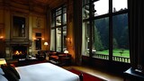 Opulent suite featuring a grand fireplace and panoramic views of lush gardens