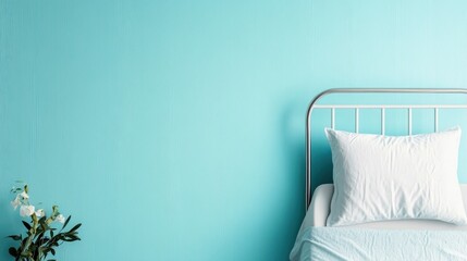Poster - A minimalist bed arrangement against a soothing blue wall presents a cozy and inviting space, ideal for relaxation and personal retreat in a contemporary interior setting.