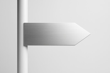 Poster - Metallic brushed aluminum arrow sign mounted on pole on plain light background for mockup, copy space or signage branding concept template use.