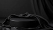 © Yuwarin - Black podium for product presentation with silk fabric on a dark background