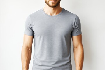 Poster - Close-up of man wearing plain grey t-shirt on light background, showing upper body and arms for fashion design or apparel branding mockup template.