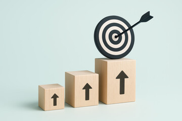 Poster - Progress and growth are symbolized by ascending cubes leading to a dartboard bullseye illustrating focus and achievement