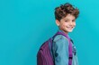 © Agent Neptunus - Young boy wearing a denim jacket and purple backpack.