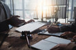 © Crystal - Lawyers working together on a legal document, reviewing and signing agreements in a courtroom setting, with a gavel and scales of justice in the background