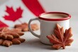 © TrubiAnna - A white mug filled with coffee sits beside maple leaf-shaped cookies. Canadian Thanksgiving. A Canadian flag is in the background, symbolizing Canada Day celebrations on July 1st.