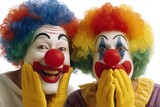 Carnival-goers dressed as clowns, who are women, provide comedic relief and silliness