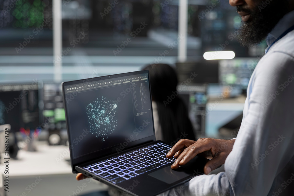 Close up of data center engineer using laptop to implement AI ...