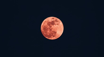 strawberry moon full in dark night sky. mystical celestial event. lunar eclipse with red or orange g