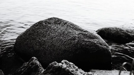 Poster - Black and white video of rocks submerged in calm water, great for nature or ocean-themed projects