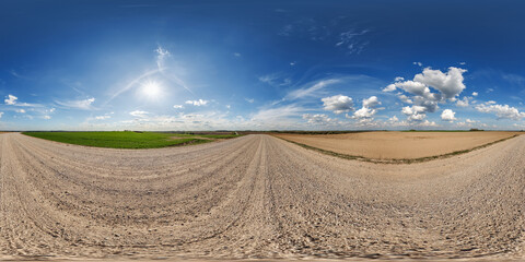 Wall Mural - hdri 360 panorama view on gravel road among fields with clouds in sky in equirectangular full seamle