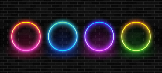 Fototapete - Four colorful neon circles on a dark brick wall background. Vibrant blank frame shapes for modern design display. Vector graphics.