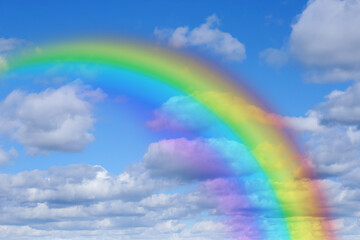 Wall Mural - bright rainbow in blue sky with clouds on sunny day