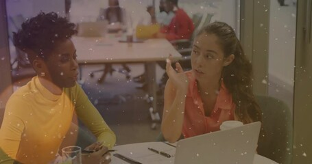 Poster - woman in orange pointing at laptop screen and guiding colleague through notes in business meeting