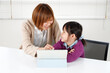 © hikari_stock - 丁寧に優しく教える女性講師を信頼する子供