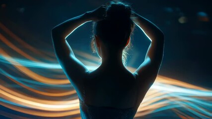 Poster - Young woman viewed from behind, adjusting hair bun with dynamic blue and orange light trails creating mesmerizing visual contrast against dark background