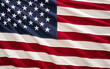 © Mr. Music - Bright colors of the American flag ripple gracefully in the breeze, showcasing its stars and stripes during a sunny day, representing national pride.
